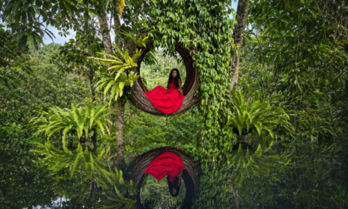 Abigail Edem Hunu seated inside a circular woven structure, symbolising holding space, safety and healing for survivors of abuse