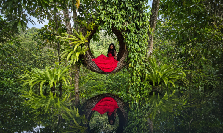Abigail Edem Hunu seated inside a circular woven structure, symbolising holding space, safety and healing for survivors of abuse